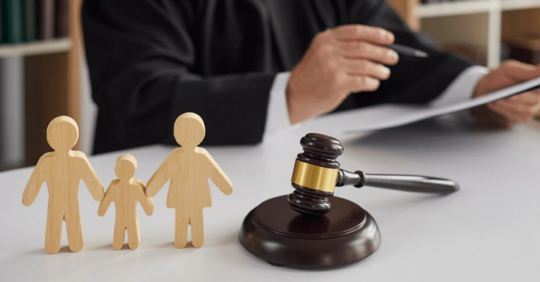 wooden family cutout and gavel on a table