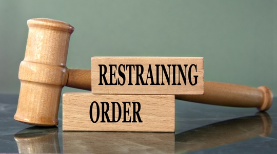 gavel next to blocks that say "restraining order"